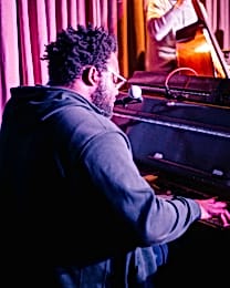 A pianist is playing and singing in a Shoreditch venue