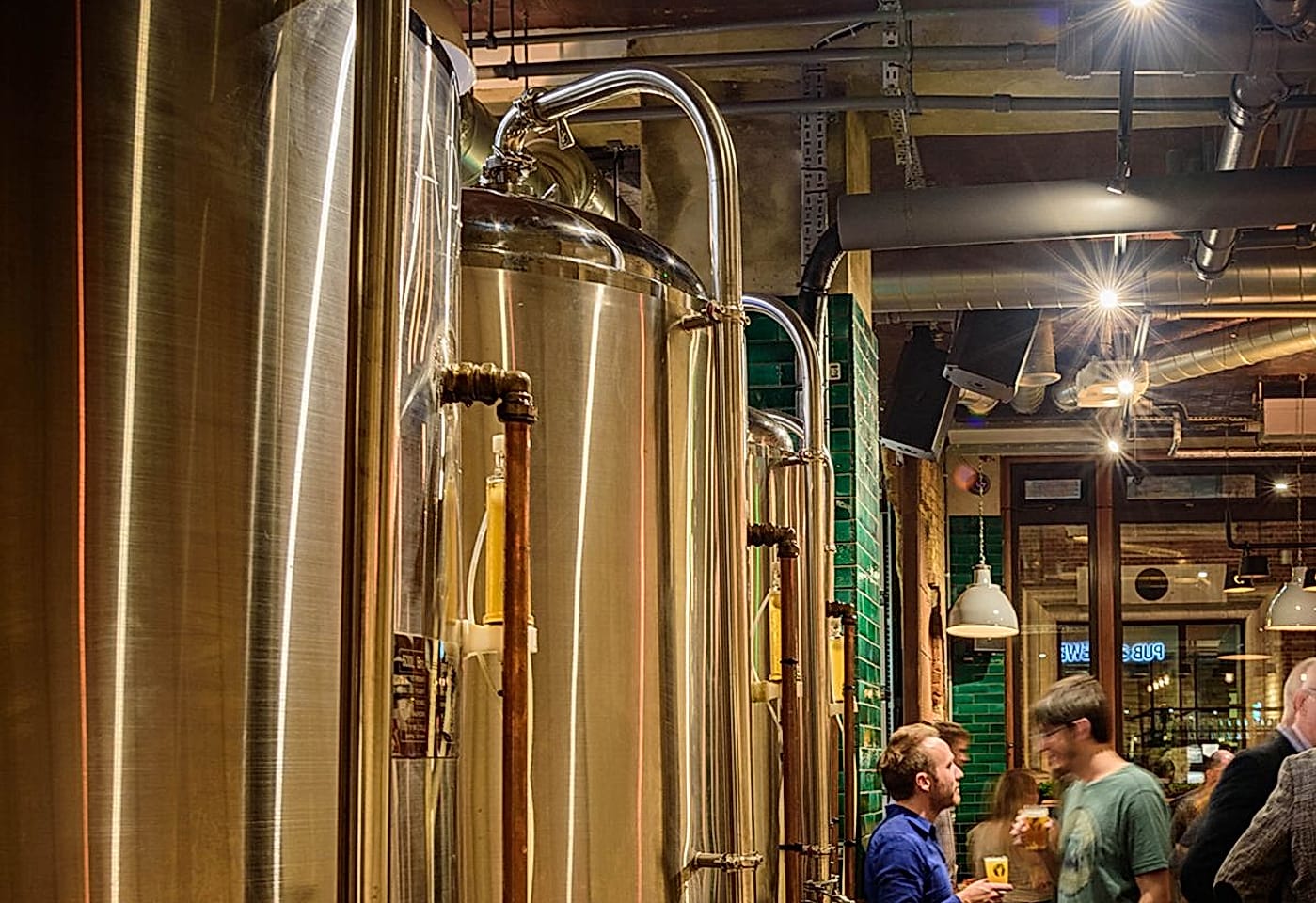 Internal brewing tanks full of beer at the Long Arm pub