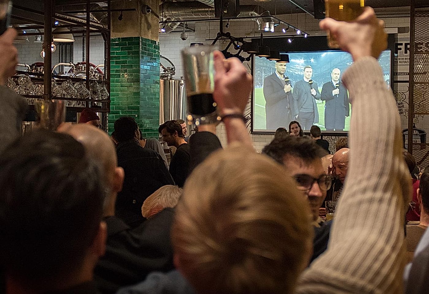 Crowds watching live sport at the Long Arm pub near Liverpool Street Station, east London