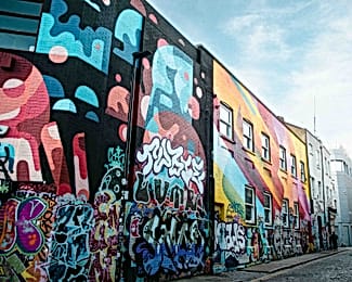 Shoreditch street with buildings covered in colourful graffiti