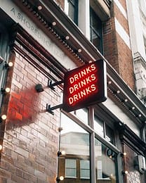 Shoreditch sign displays the words 'drinks drinks drinks'