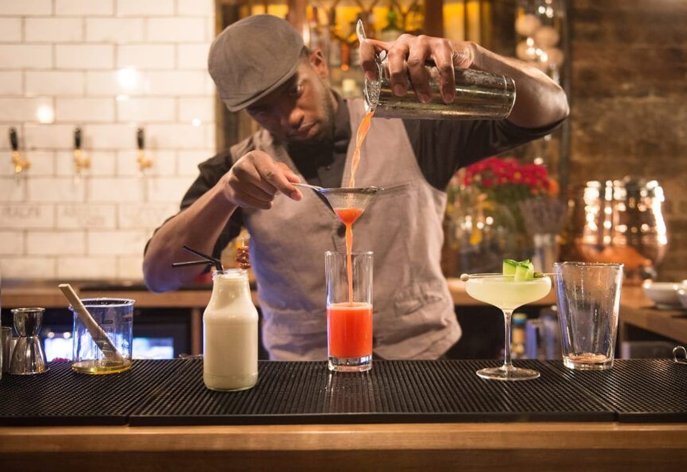 A bartender mixing drinks at Dirty Dicks, a pub near Liverpool Street