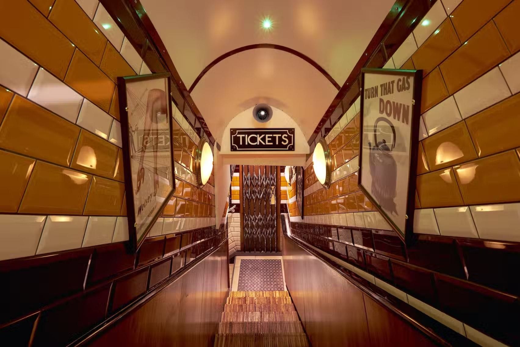 The stairs down to Cahoots, a Tube-themed cocktail bar in Soho, London