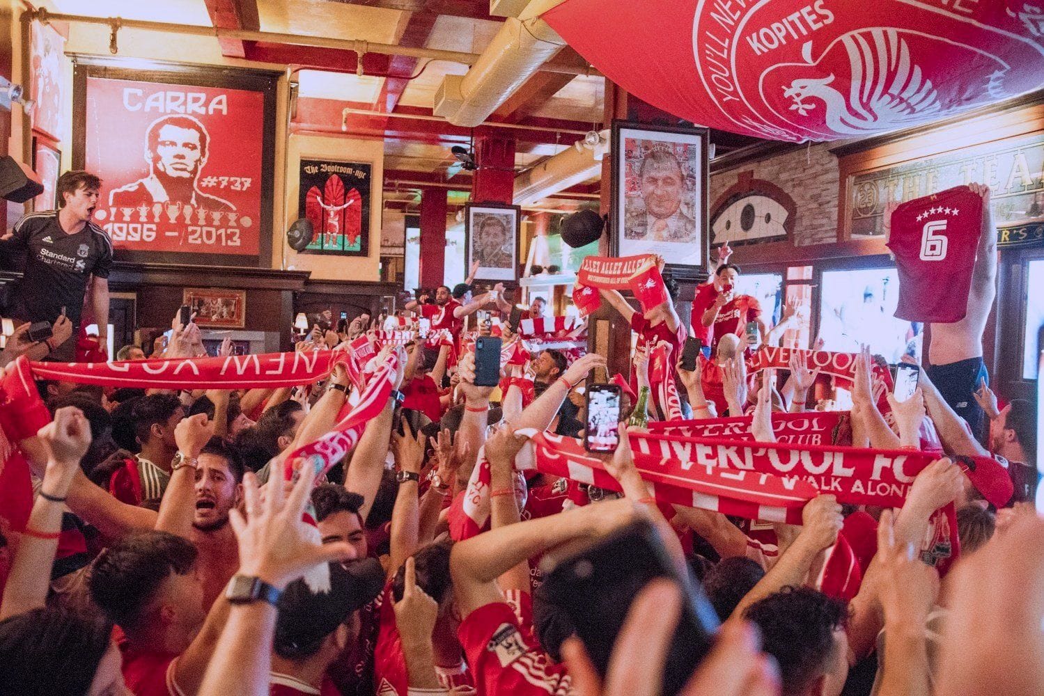 Liverpool FC fans celebrating at Carragher's, a sports bar in NYC. 