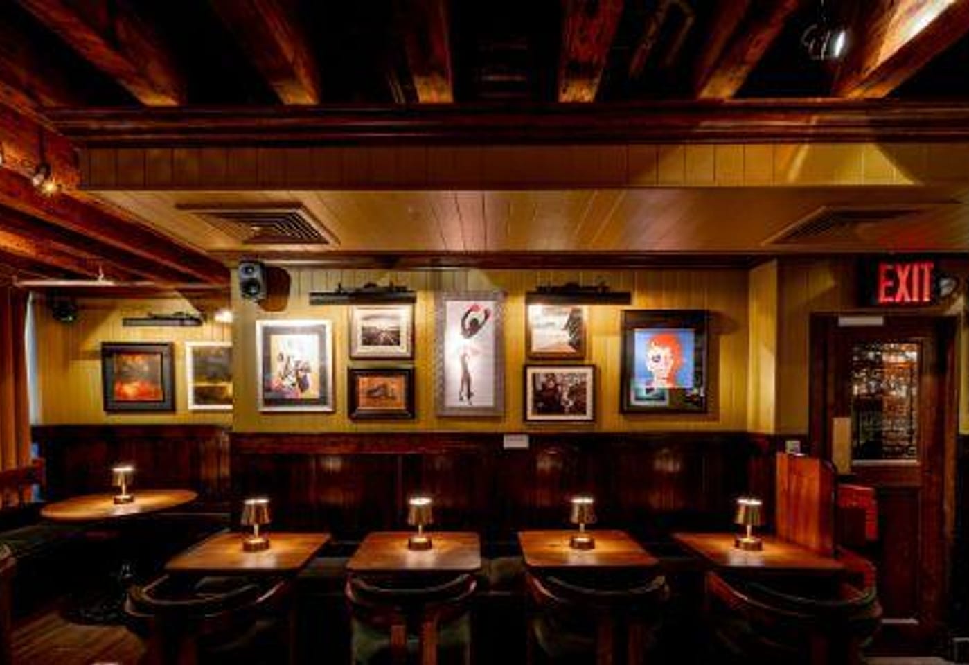 Seating area featuring a wide variety of artwork at The Dead Rabbit NYC, a bar for celebrating 21st birthdays in New York.