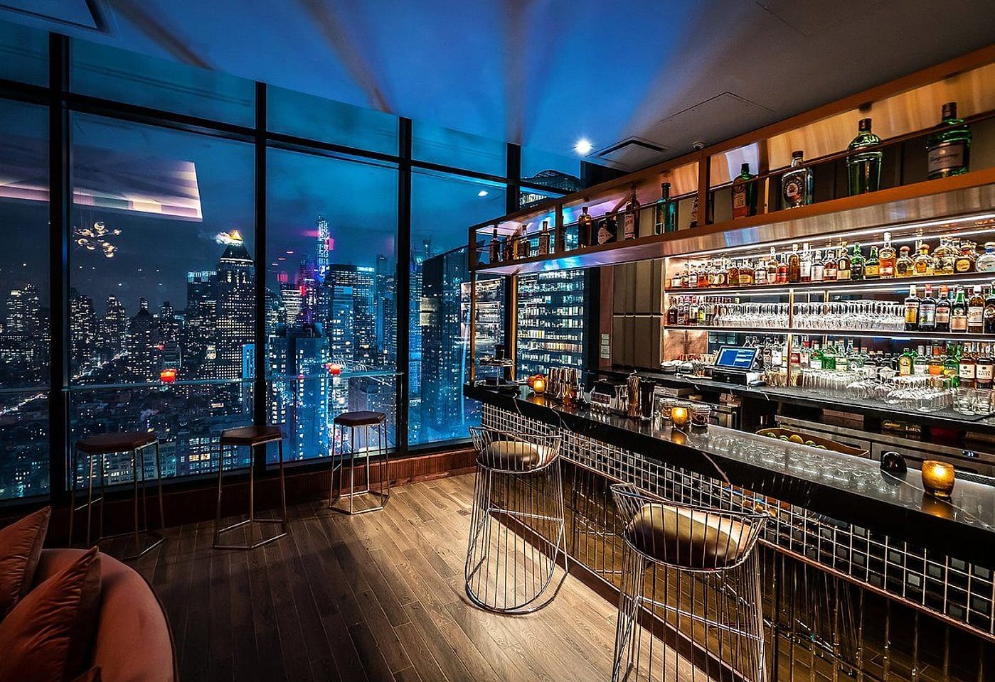 A counter alongside sweeping windows overlooking Midtown at Dear Irving on Hudson, a bar for celebrating 21st birthdays in New York.