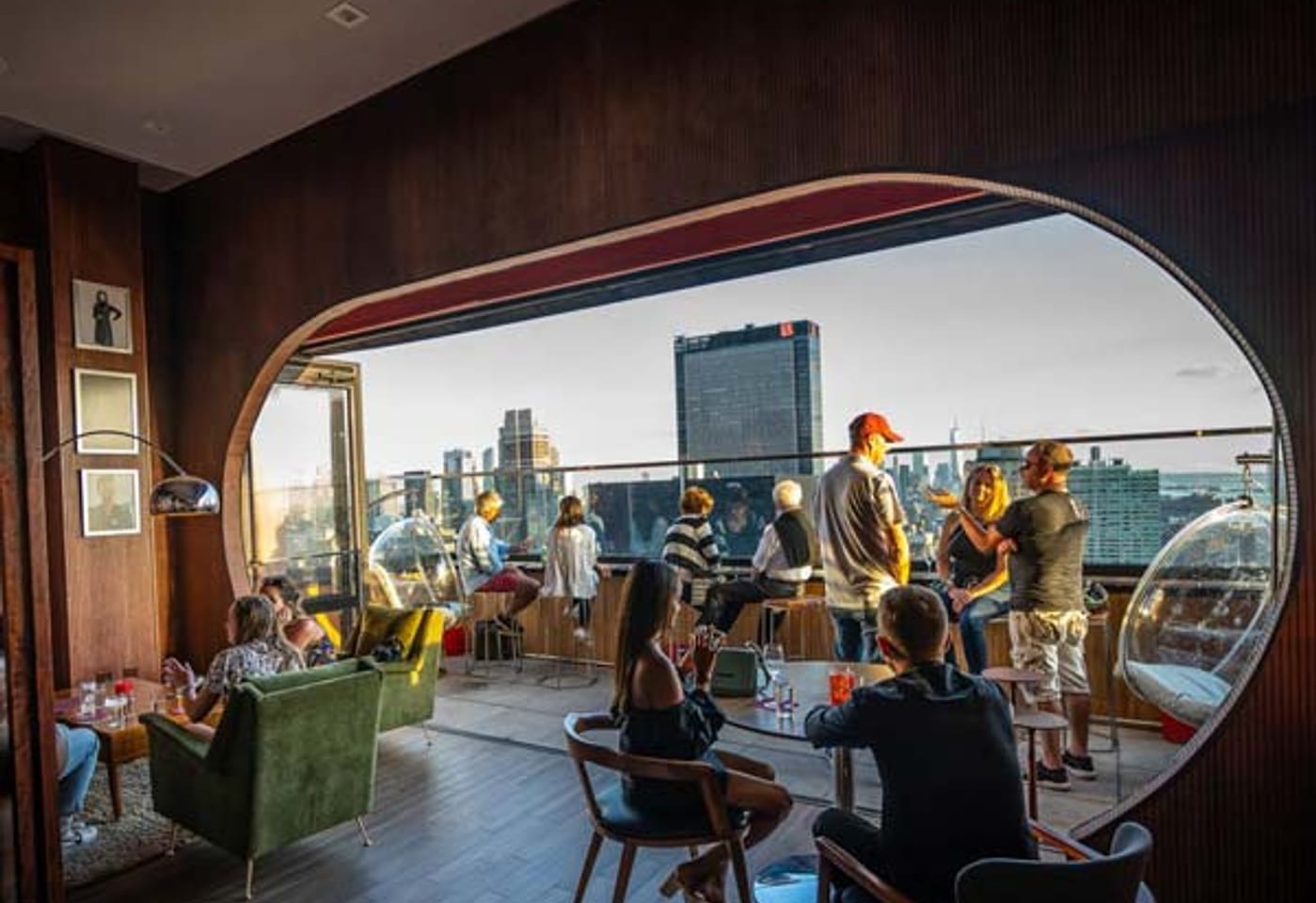 People drinking on an outdoor terrace at Dear Irving on Hudson, a bar for celebrating 21st birthdays in New York.