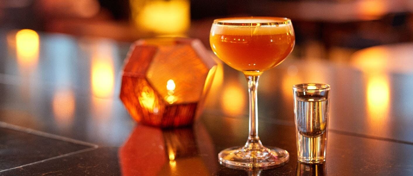 cocktail and candle at ga kingsx bar and restaurant in kings cross london