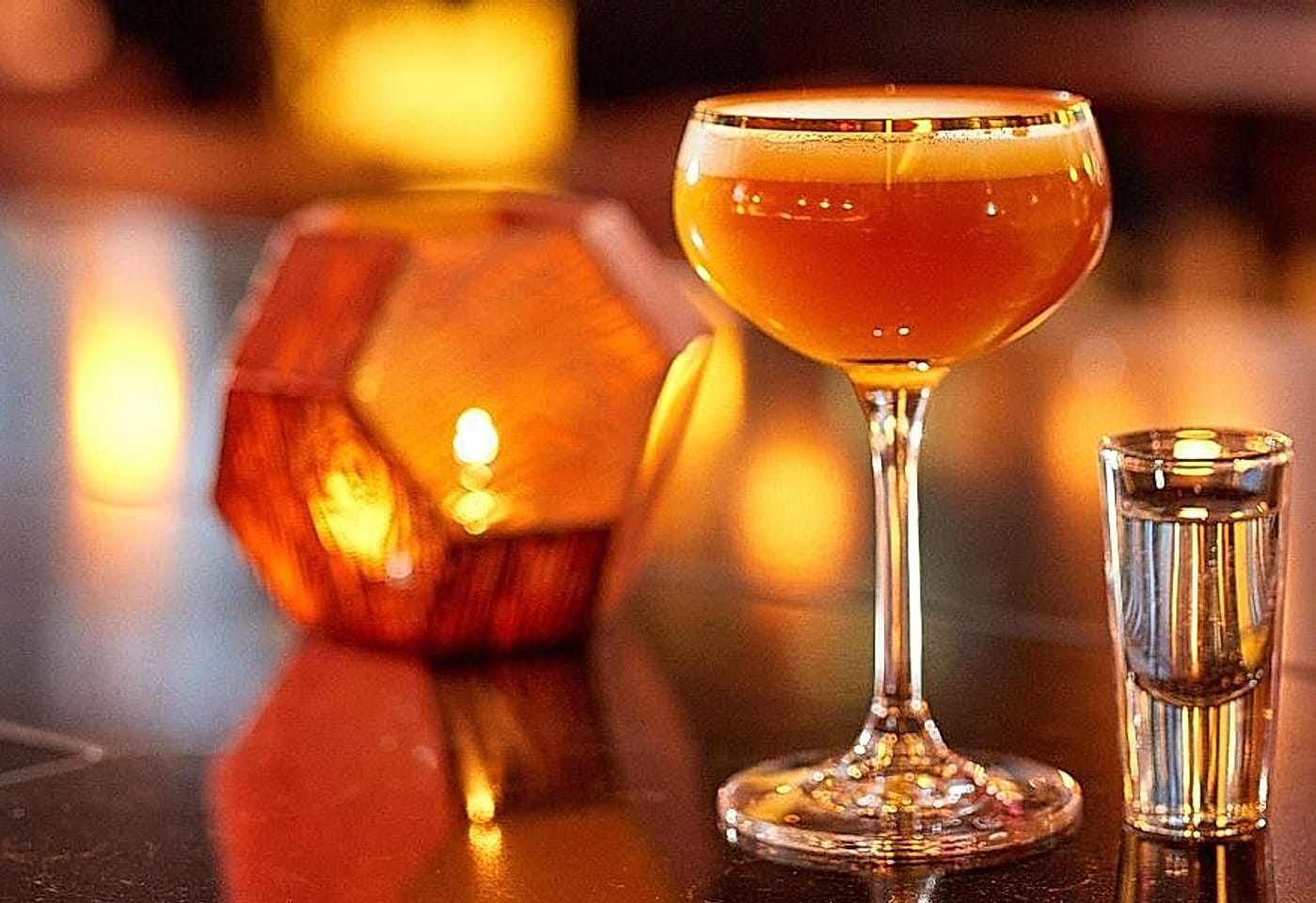 cocktail and candle at ga kingsx bar and restaurant in kings cross london