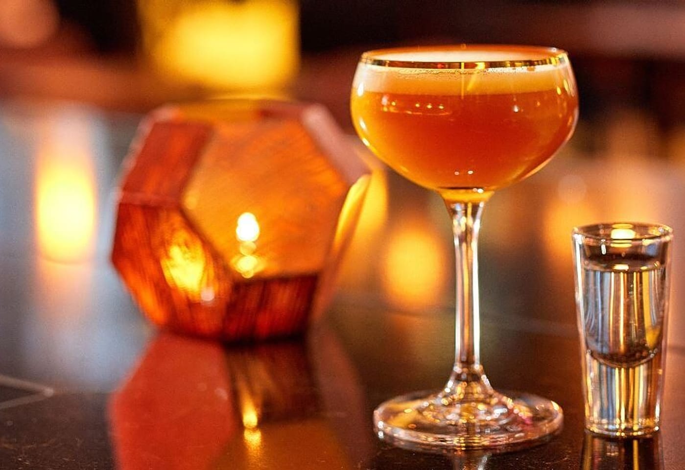 cocktail and candle at ga kingsx bar and restaurant in kings cross london