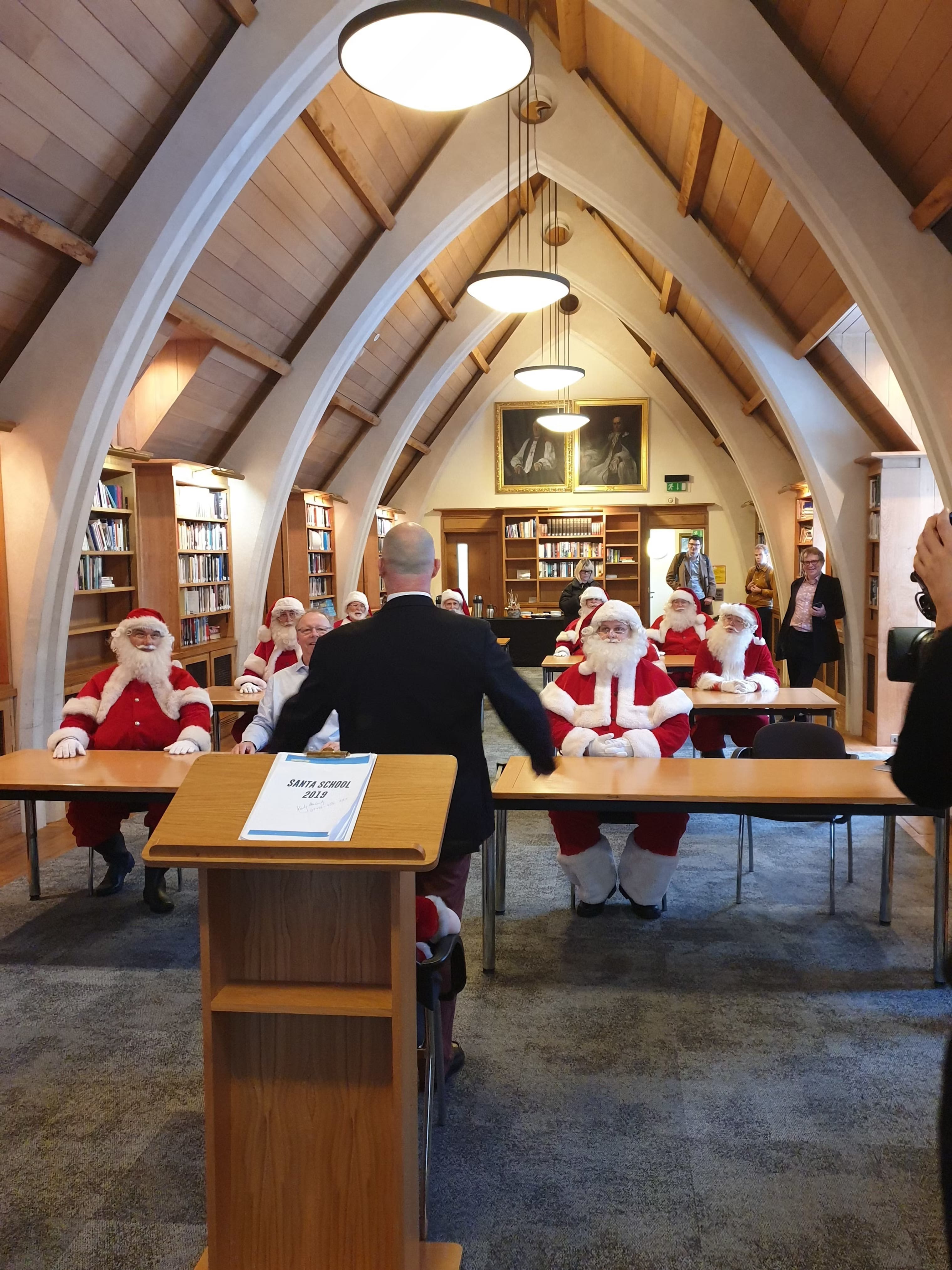 a group of santas at the meeting room at the garry weston library at southwark cathedral
