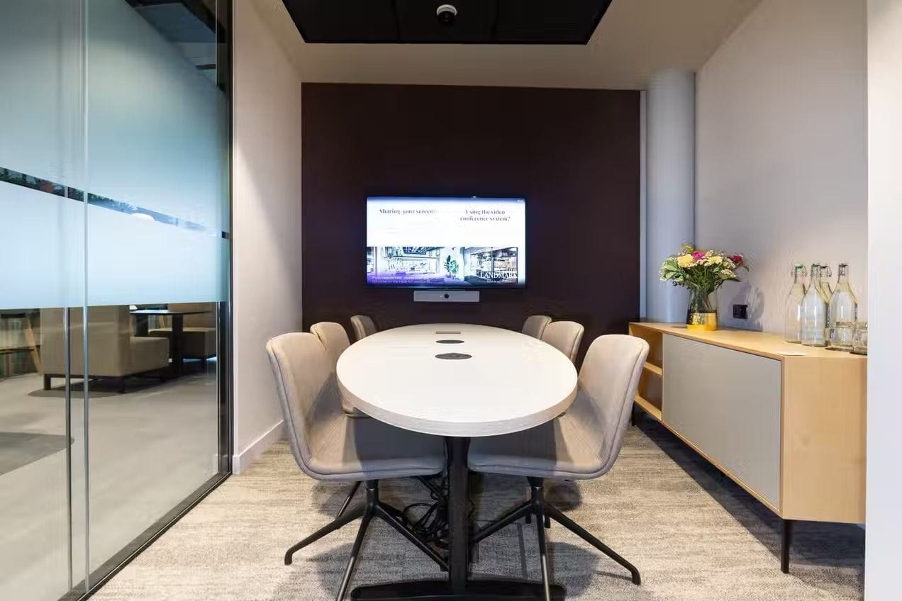 A mid-sized meeting room in London with TV screen