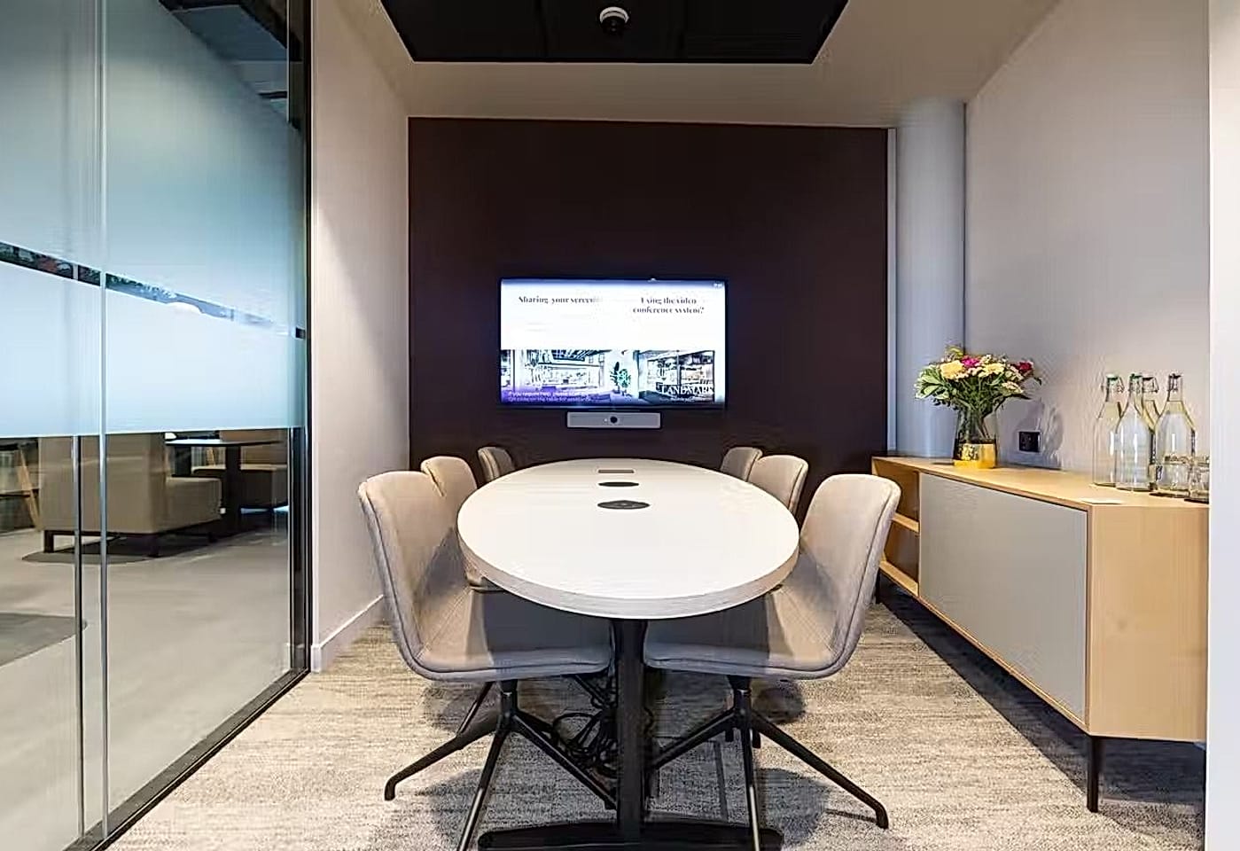 A mid-sized meeting room in London with TV screen
