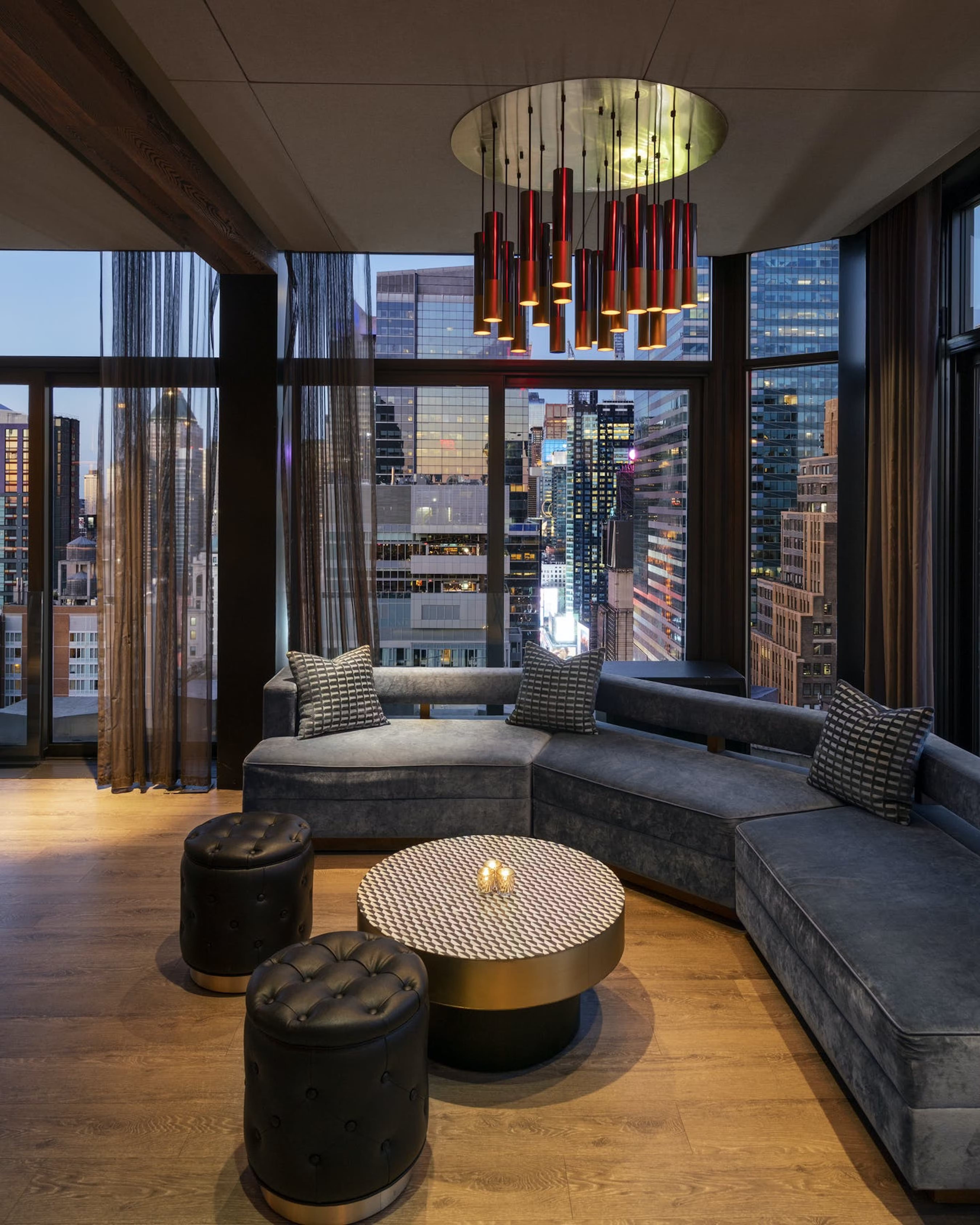 A large couch overlooking the Midtown skyline at The Skylark, a bar for celebrating 21st birthdays in New York.