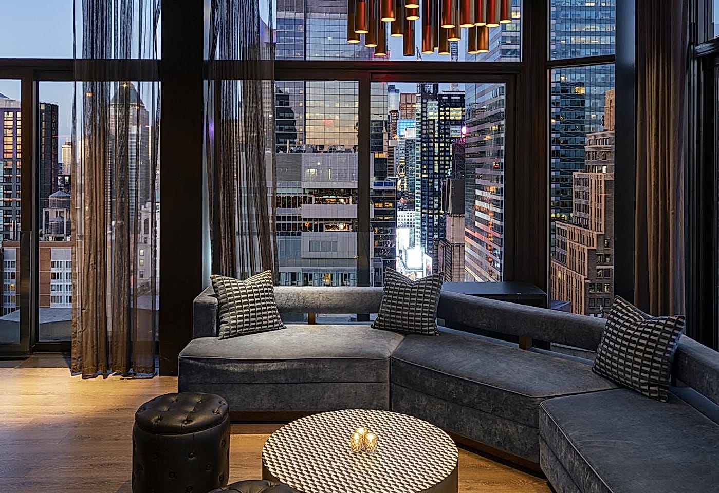 A large couch overlooking the Midtown skyline at The Skylark, a bar for celebrating 21st birthdays in New York.