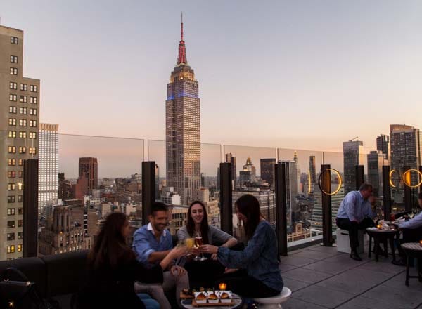 An outdoor terrace with views of the Empire State Building at The Skylark, a bar for celebrating 21st birthdays in New York.
