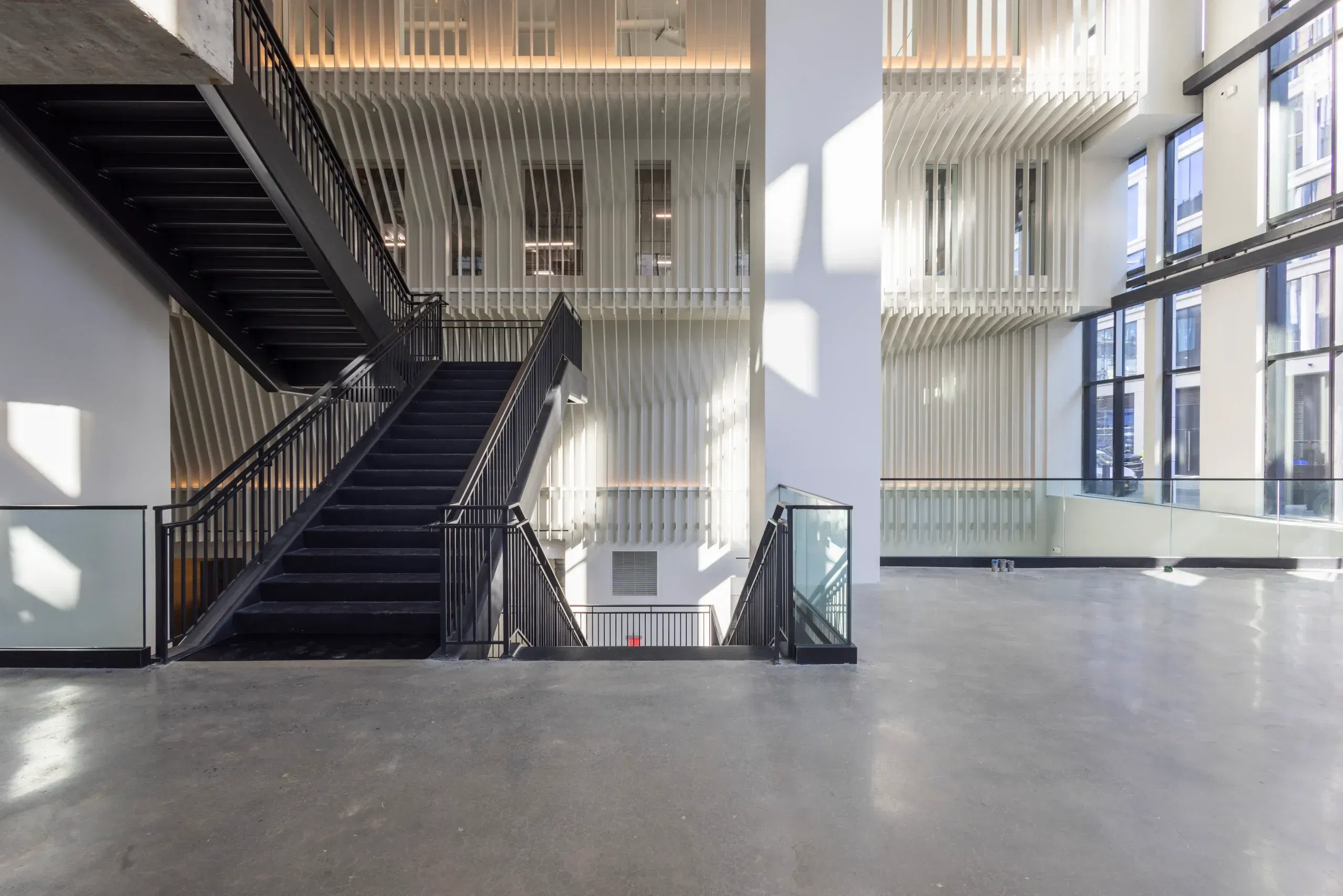 A large staircase inside Skylight at Essex Crossing, a conference venue on the Lower East Side in NYC.