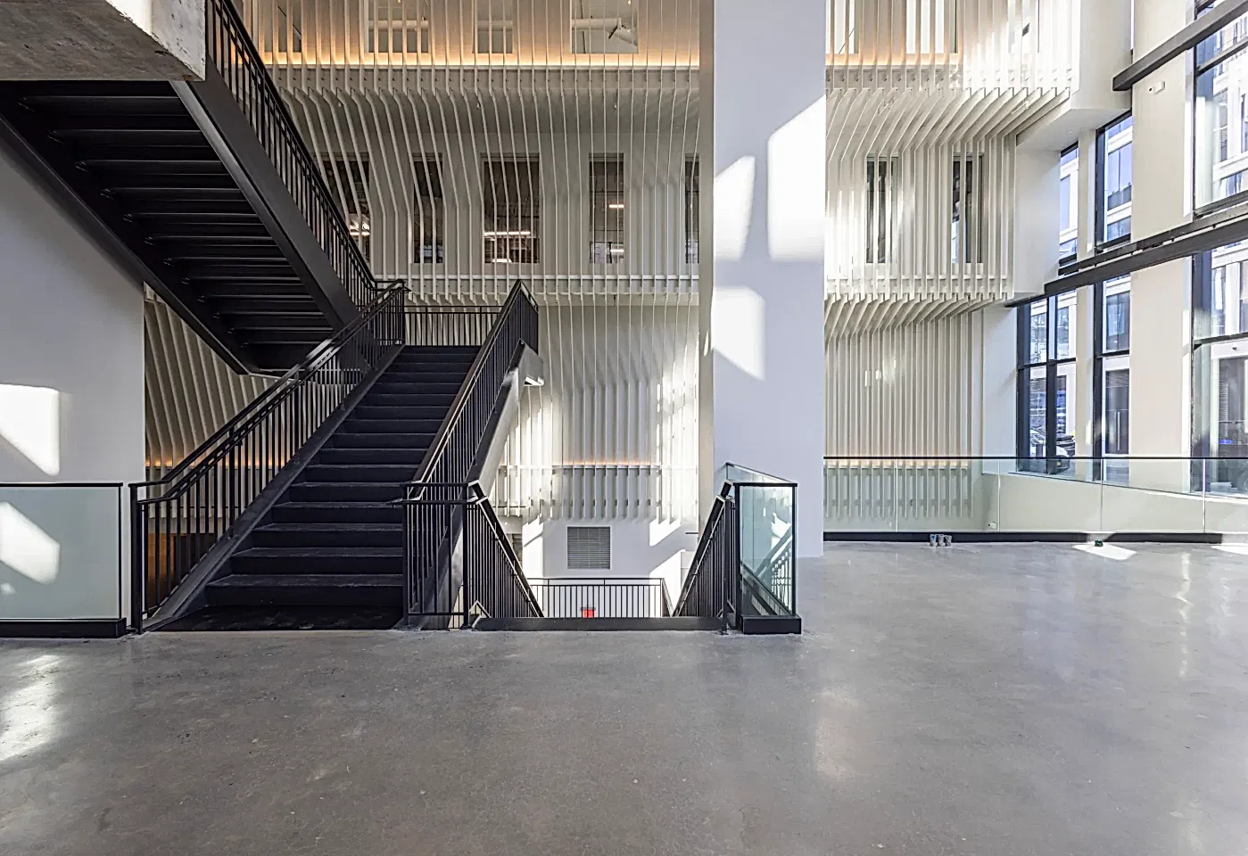 A large staircase inside Skylight at Essex Crossing, a conference venue on the Lower East Side in NYC.