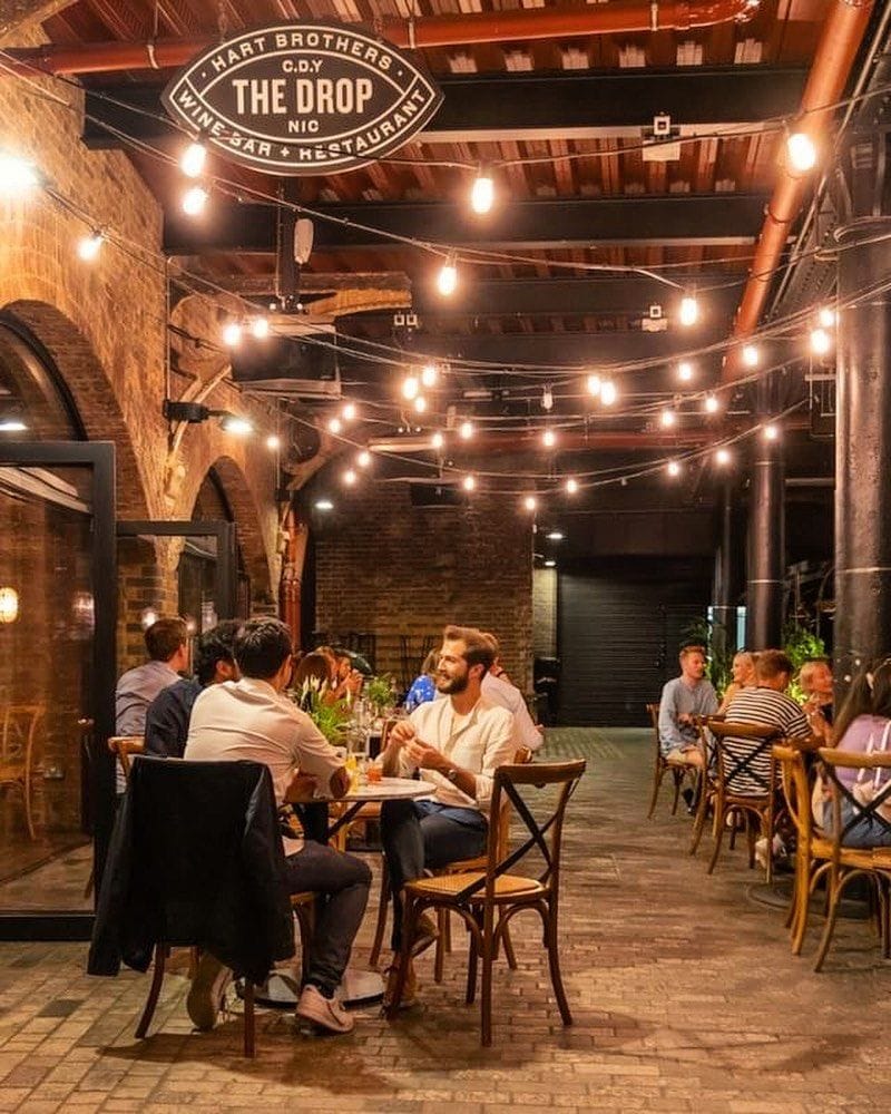 people at the drop wine bar in kings cross london