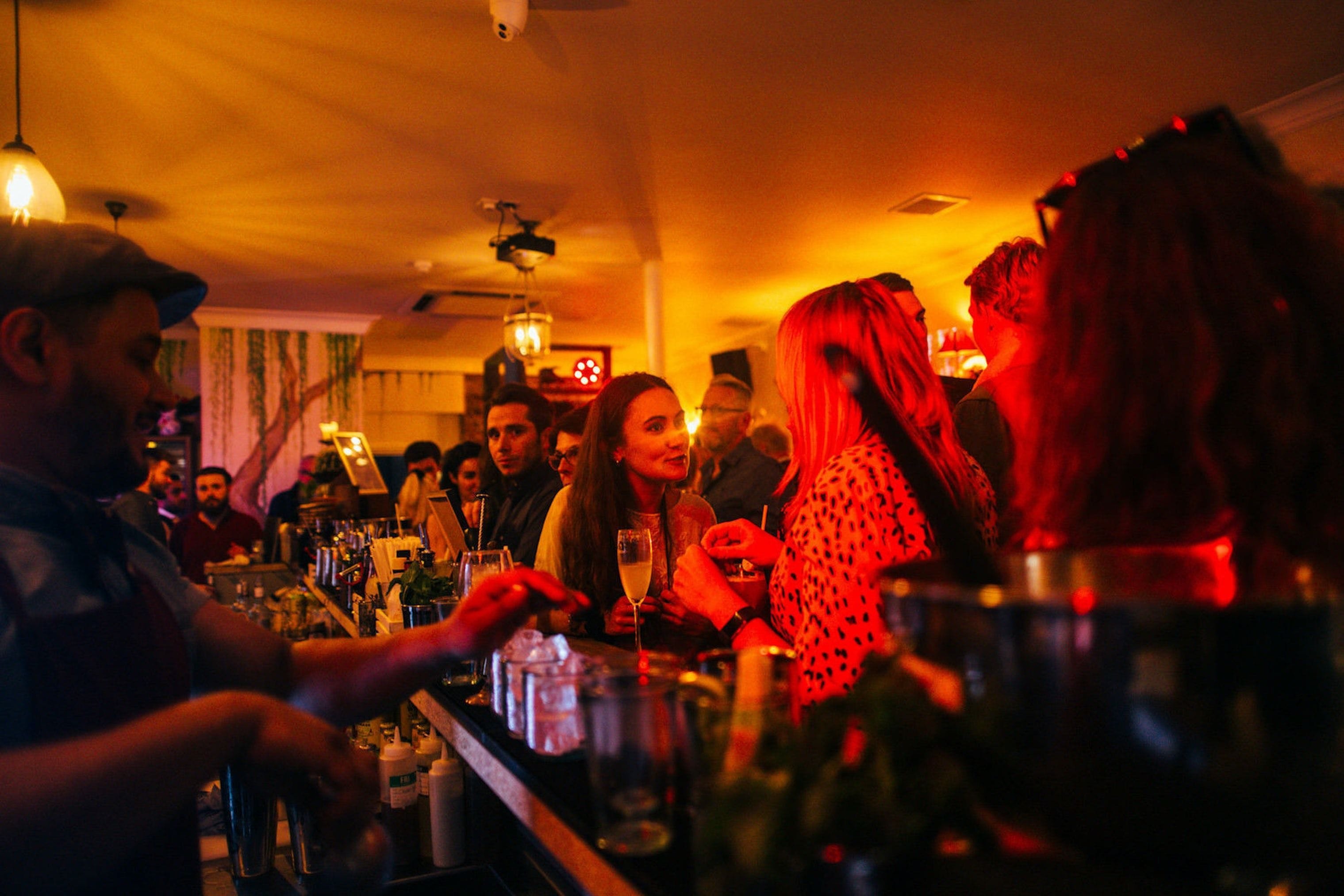 people at the little blue door fulham london bar