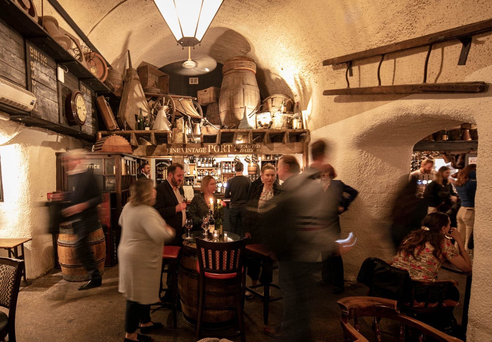 people under the arched ceilings of the London Bridge bar the Mug House wine bar